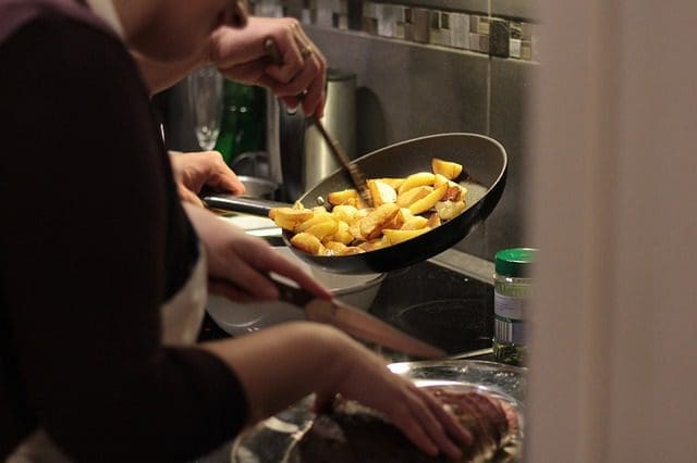 food in a pan being held by a person