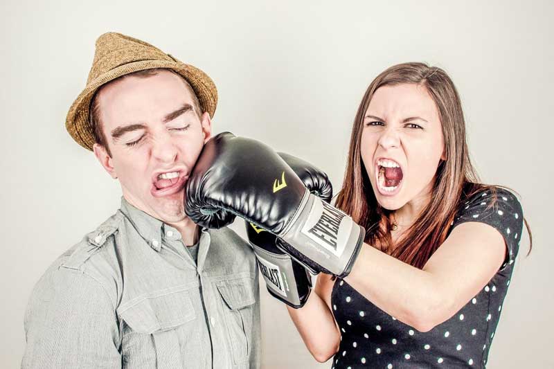 Girl Punching Guy With Boxing Gloves