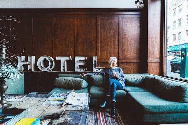woman sitting on a couch in a hotel