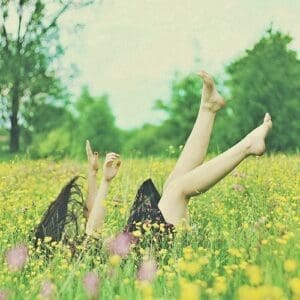 Lady laying in the field with feet in the air