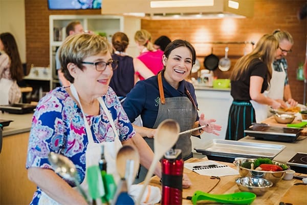groups in pairs at cooking class at chef alyssa's kitchen
