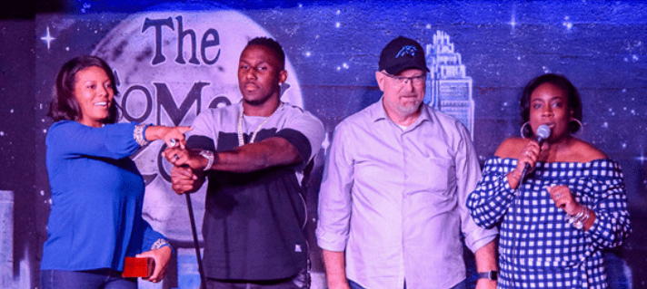 4 people on stage at the comedy zone interacting with crowd